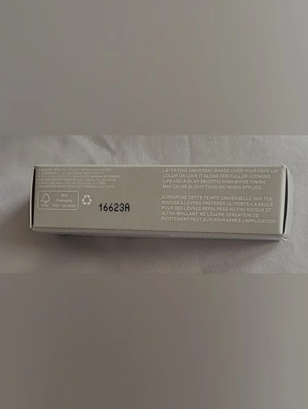 r.e.m. beauty On Your Collar Plumping Lip Gloss in the shade Utmost Importance.